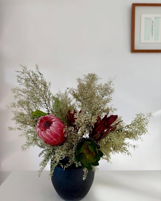 Rustic arrangement in a black vase
Flowers and foliages are from bloombrokers