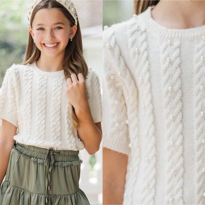 Timeless and sweet 🤍 This cream pearl knit sweater features a rounded crew neckline with ribbed trim, short sleeves with ribbed cuffs, a straight hemline, and moderate stretch in the knit fabric. Delicate pearl details on the cable knit pattern add classic charm for her fall wardrobe ✨ Check out our exclusive Sunday Selects for more coordinating looks!

$42 >> Girls: The Class Act Cream Pearl Knit Sweater
